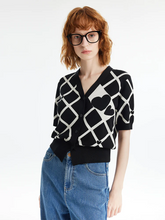 a lady in a black and white v-neck plaid jacquard cardigan